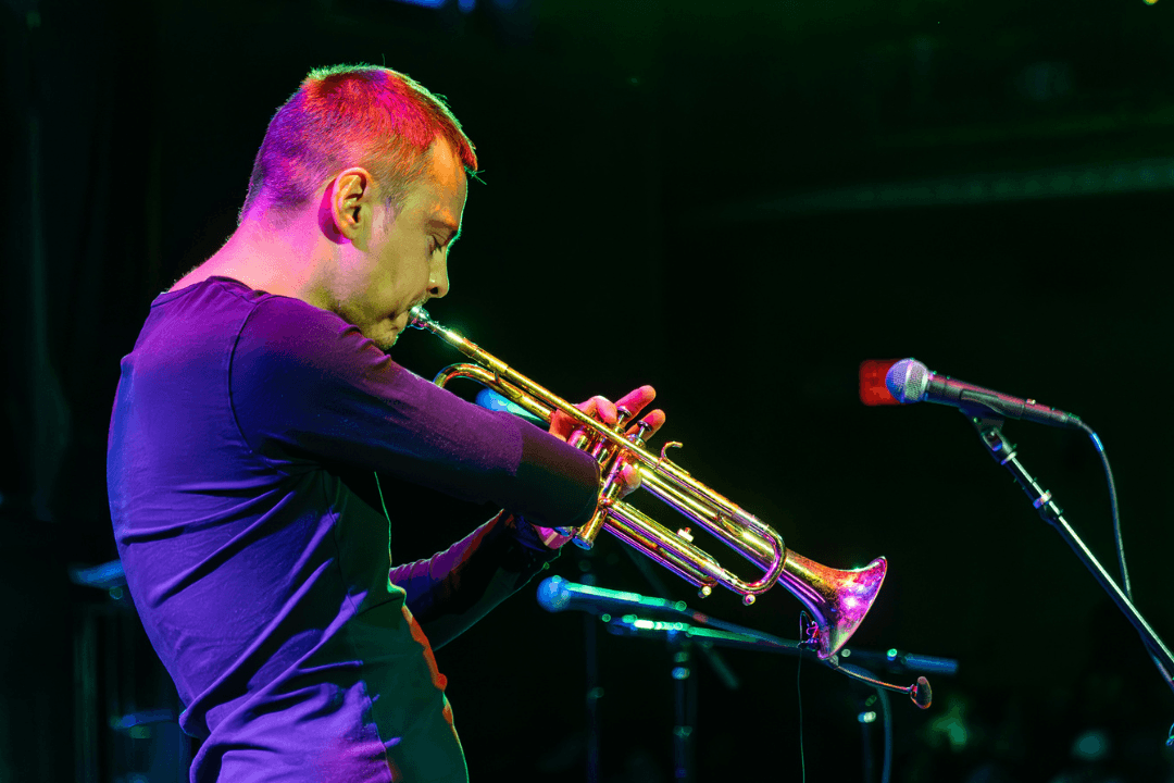 Photo of Barabas playing the trumpet at the fifth annual Danny Awards. He is using a special apparatus to support the instrument, as he does not have a right forearm. 