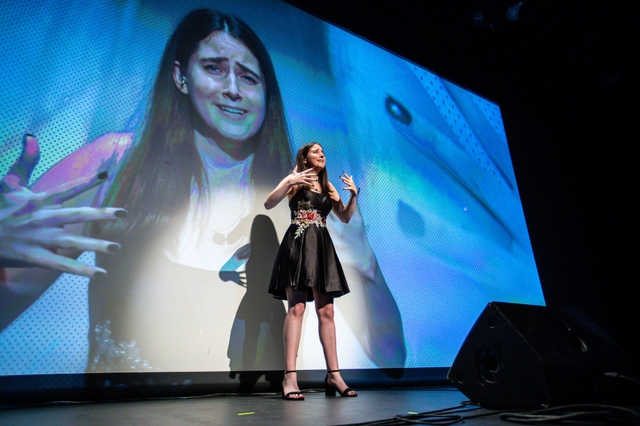 Erin performs a song in American Sign Language