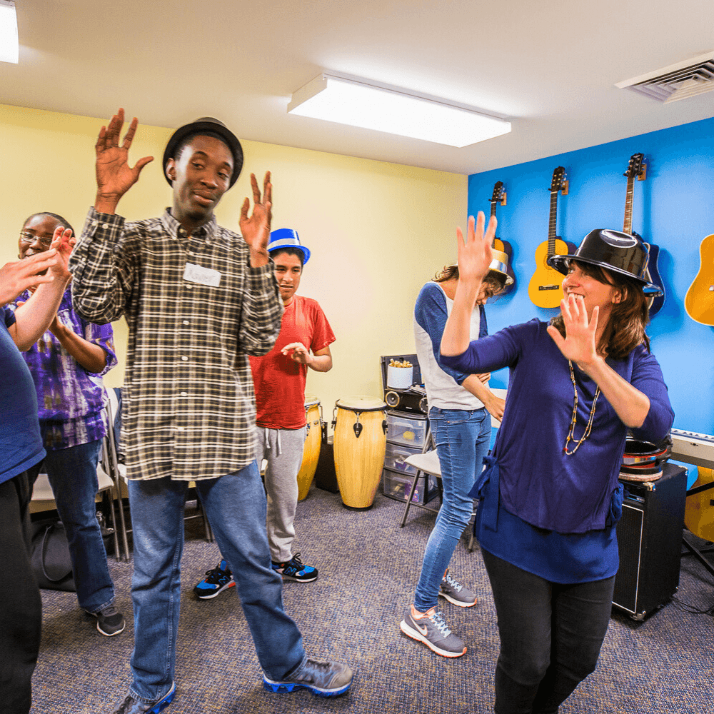 Members dancing with new years hats on