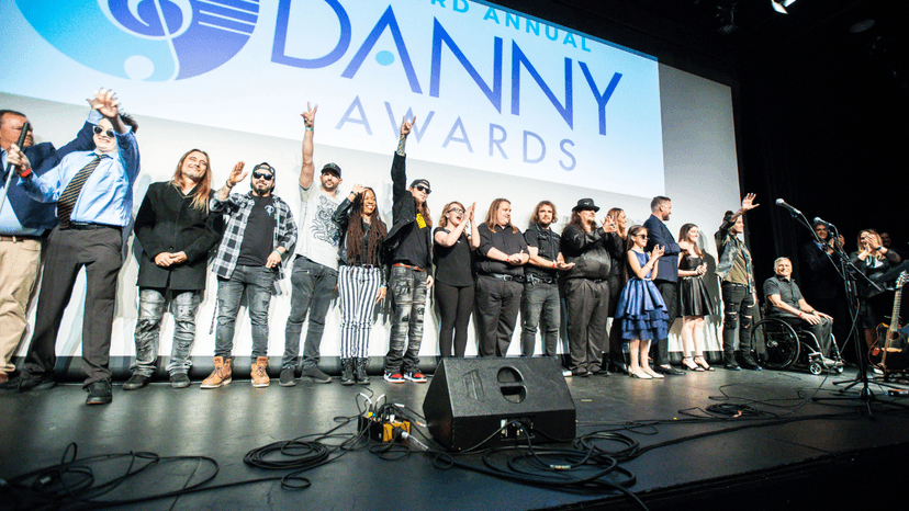 Photo of the Third Annual Danny Award recipients standing in a line and smiling for a curtain call