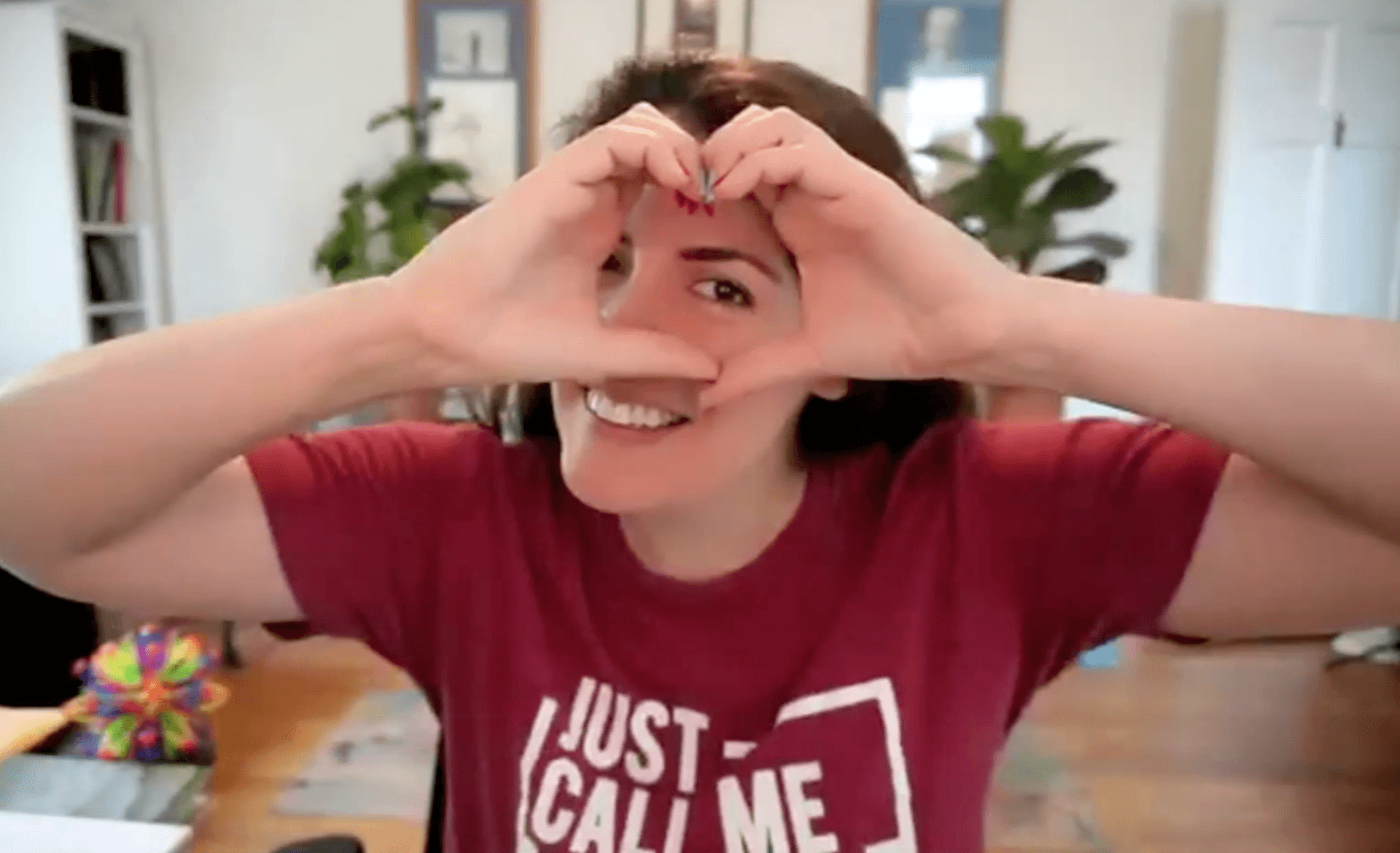 Photo of Jen making a heart with her hands