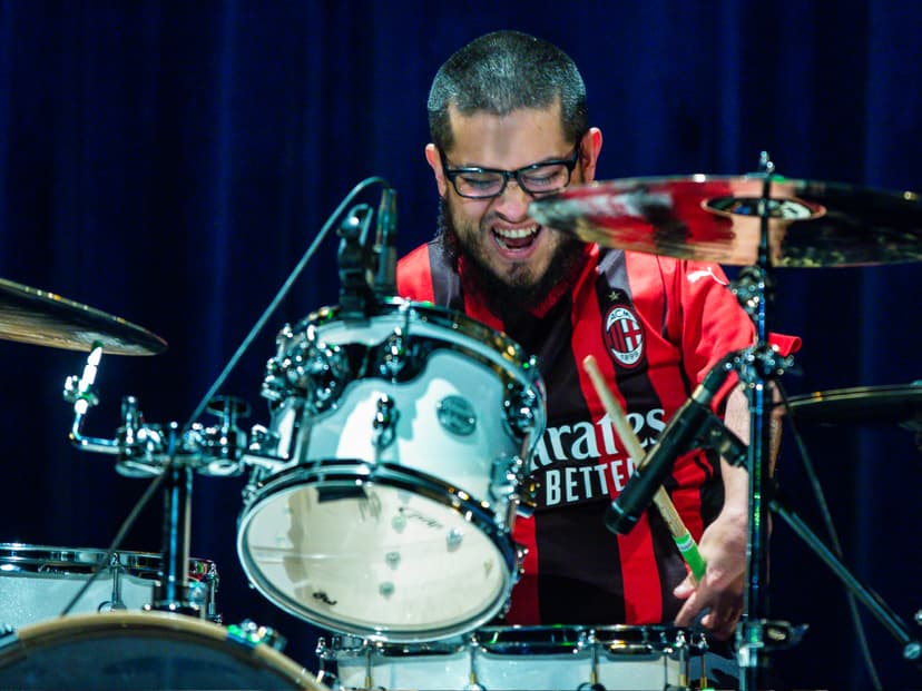 Danny Award recipient Carlos Guevara plays the drums on stage