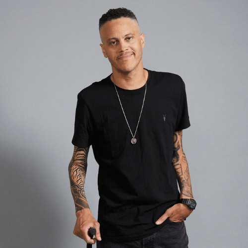 Photo of James Ian, a young man with light complexion and short curly hair. He is weariing a tan shirt.